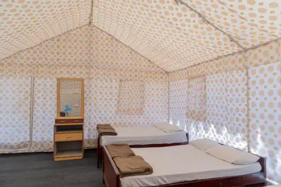 a room with two beds in a tent at Coorg Kavery Estate by Aarika Resorts in Napoklu