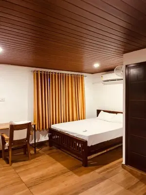 a bedroom with a bed and a chair in it at River bendHome in Viripara