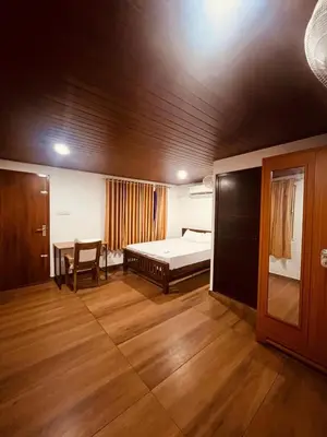 a bedroom with a bed and a table and a chair at River bendHome in Viripara