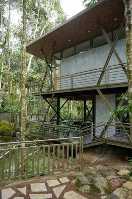 a building with a deck in the woods at RockS VillA in Meppādi