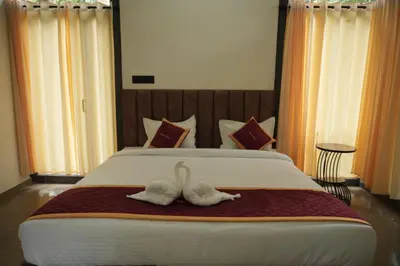 two swans sitting on top of a bed at RockS VillA in Meppādi
