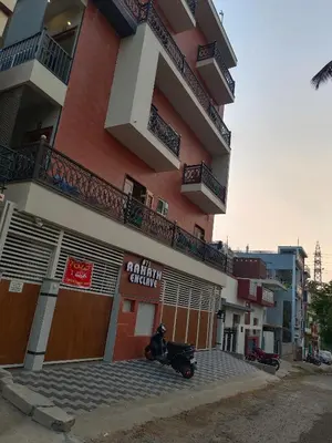 a motorcycle parked in front of a building at Royal Stay Mysuru Service Apartment in Mysore