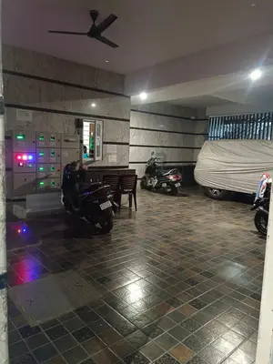 a room with a bed and motorcycles parked in it at Royal Stay Mysuru Service Apartment in Mysore