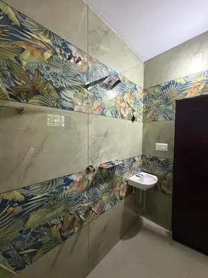 a bathroom with a sink and a mosaic wall at ACK River Palms - Athirappilly in Athirappally
