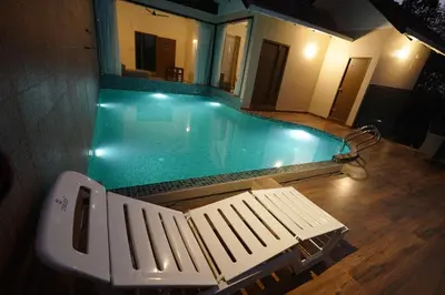 a swimming pool with a bench in front of it at Mountain Vista Resorts LLP