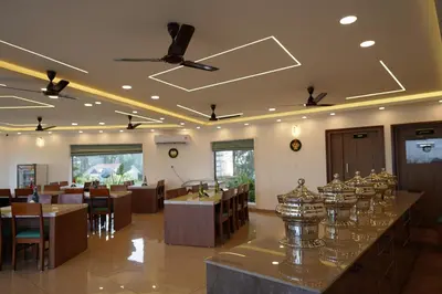 a restaurant with tables and chairs and a bar at Mountain Vista Resorts LLP