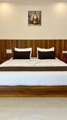 a bedroom with a large bed with wooden walls at Estoria Hotel and Resort in Mysore