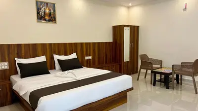 a bedroom with a large bed in a room at Estoria Hotel and Resort in Mysore