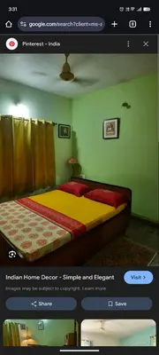 a bedroom with a bed in a room with green walls at Star Homestay in Vālpārai