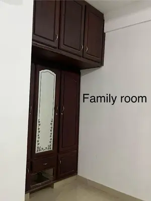 a wooden cabinet with a mirror in a room at Vrindhavan stay and rooms in Guruvāyūr