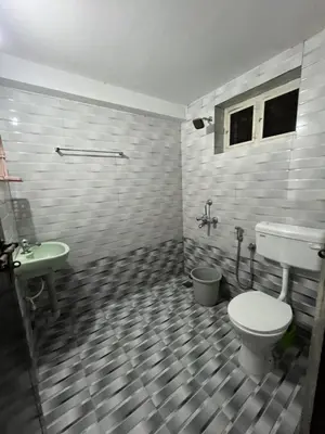 a bathroom with a toilet and a sink at Vrindhavan stay and rooms in Guruvāyūr