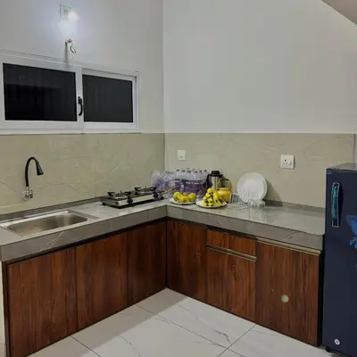 a kitchen with a sink and a counter top at KM Villa in Kottakkal