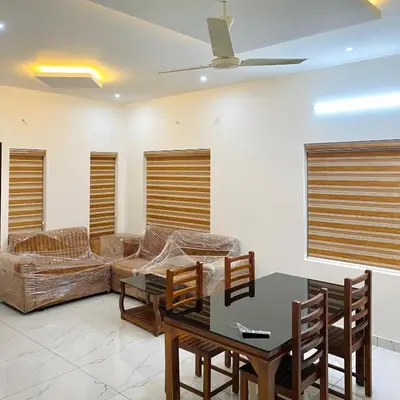 a living room with a couch and a table at KM Villa in Kottakkal