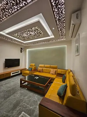 a living room with a couch and a tv at Kurunchi Malar Resorts in Hosūr