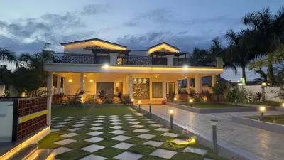 a house with a checkered floor in front of it at Kurunchi Malar Resorts in Hosūr