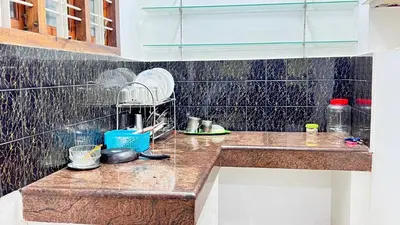 a kitchen with a counter with a mixer on it at Royal Rivera Holiday Home in Kalpetta
