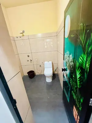 a bathroom with a white toilet in a room at Ocean pearl homestay-pariyaapuram