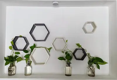 a group of mirrors hanging on a wall with vases at Riverfront Villa in Kochi in Kodungallūr