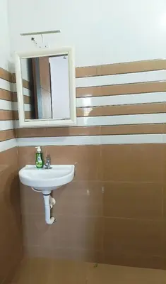 a bathroom with a sink and a mirror at Riverfront Villa in Kochi in Kodungallūr