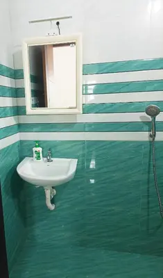 a bathroom with a sink and a mirror at Riverfront Villa in Kochi in Kodungallūr