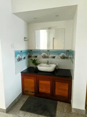 a bathroom with a sink and a mirror at Riverfront Villa in Kochi in Kodungallūr