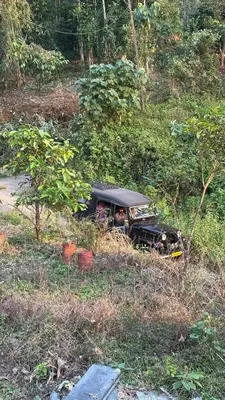 a car sitting in the middle of a field at The Elephant watch in Viripara