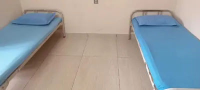 two bunk beds in a room with a wooden floor at Sithara Guest House in Palakkad
