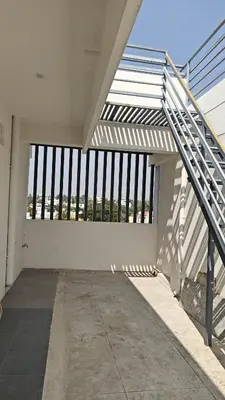 an empty room with a staircase in a building at Gamani in Mysore