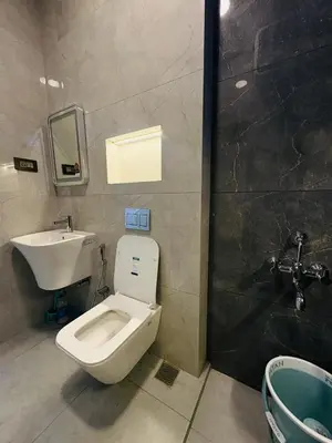 a bathroom with a toilet and a sink at Little Home By D2V in Ooty