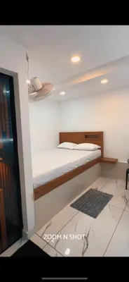 a bedroom with a bed in a room at Ichakkans beach resort in Irimbranallūr