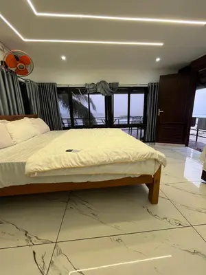 a bed in a room with a large window at Ichakkans beach resort in Irimbranallūr