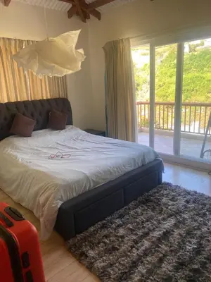 a bedroom with a bed and a large window at Neom Valley in Ketti