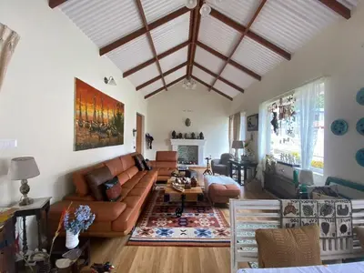 a living room with a couch and a table at Neom Valley in Ketti