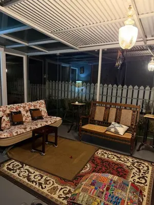 a living room with two couches and two rugs at Neom Valley in Ketti