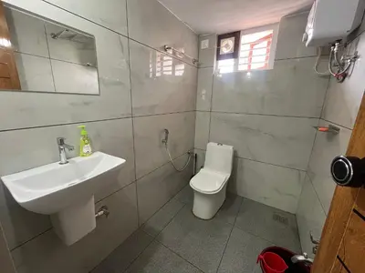 a bathroom with a sink and a toilet at AGNEYA Holiday Home in Wayanad