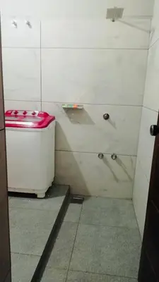 a small bathroom with a toilet in a shower at AGNEYA Holiday Home in Wayanad