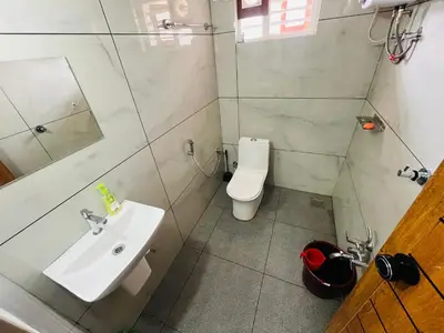 a bathroom with a sink and a toilet at AGNEYA Holiday Home in Wayanad