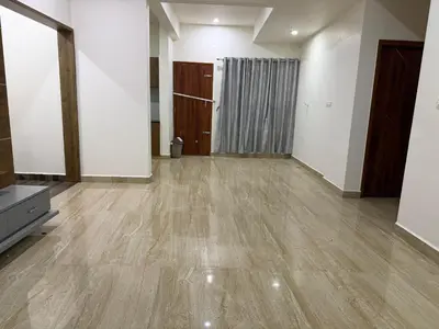 an empty room with wooden floors and white walls at The Residence 267 Home Stay in Mysore