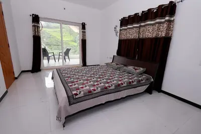 a bedroom with a bed and a large window at Hillside haven ooty in Ooty