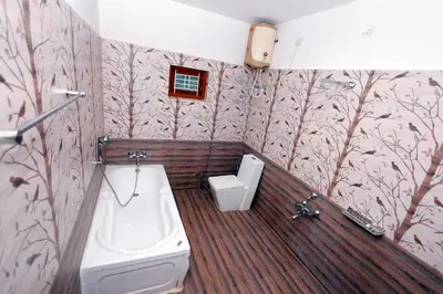 a bathroom with a toilet and a sink at Hillside haven ooty in Ooty