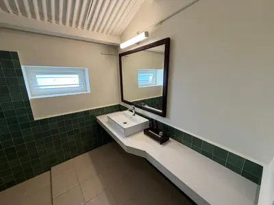 a bathroom with a sink and a mirror at Ellem House in Kotagiri