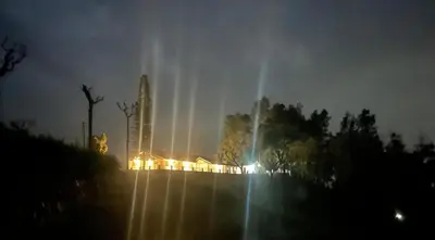 a fountain with lights in a city at night at Ellem House in Kotagiri