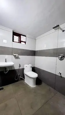 a bathroom with a toilet and a sink at Wildora Junglevilla Wayanad in Chekadi