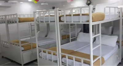 a group of bunk beds in a room at Hamai Grand Dormitory in Ambalavayal