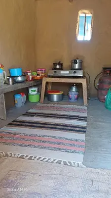 a kitchen with pots and pans on a table at Mud bees resort in Kanthalloor