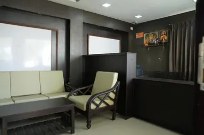 a waiting room with a chair and a desk at Luxury Stays in Coimbatore
