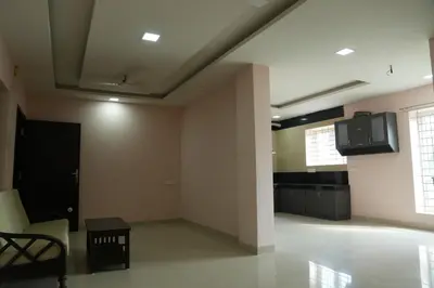 a living room with a couch and a table at Luxury Stays in Coimbatore
