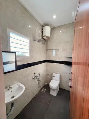 a bathroom with a toilet and a sink at Nexusliving in Coimbatore