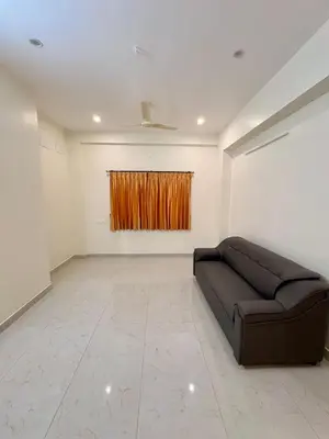 a living room with a couch and a painting at Nexusliving in Coimbatore