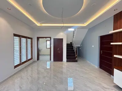 a living room with a coffered ceiling and a staircase at House of KRM - Nilgiris Outlook in Kāramadai
